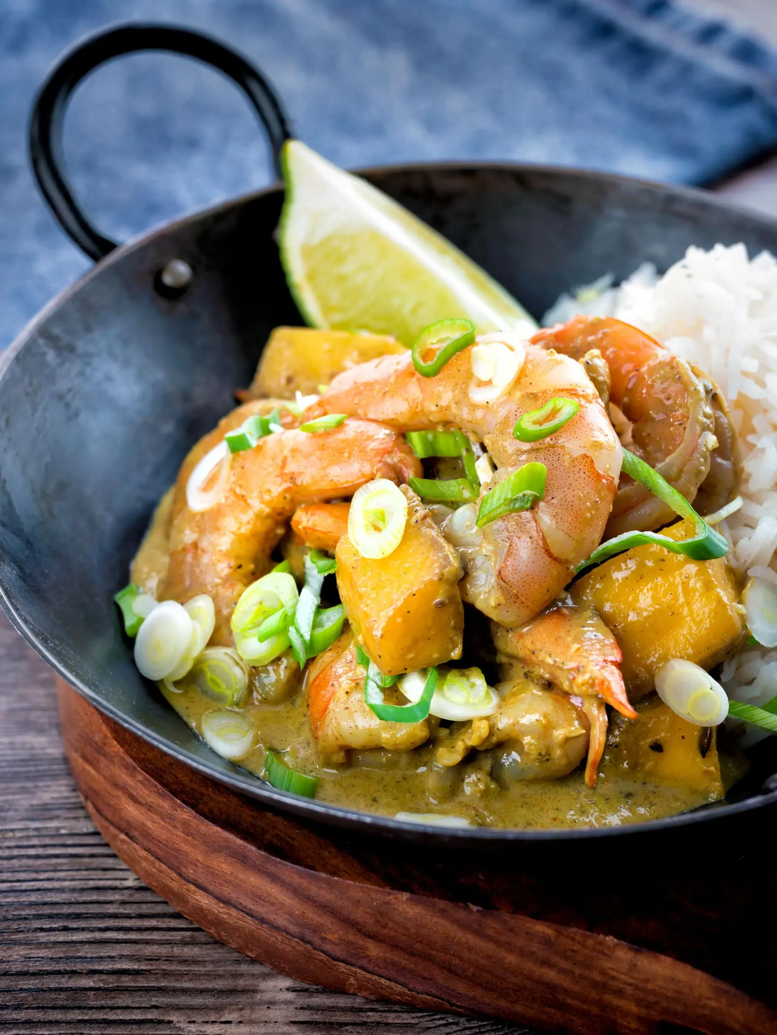 prawn and mango curry with rice in a pan