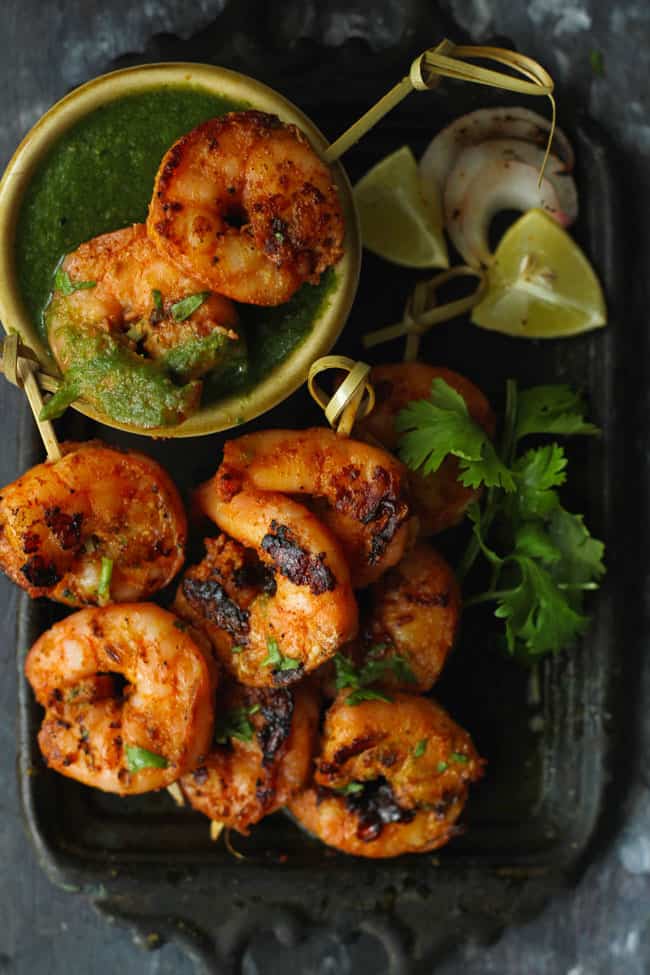 Tandoori Prawns served on a platter with chutney 