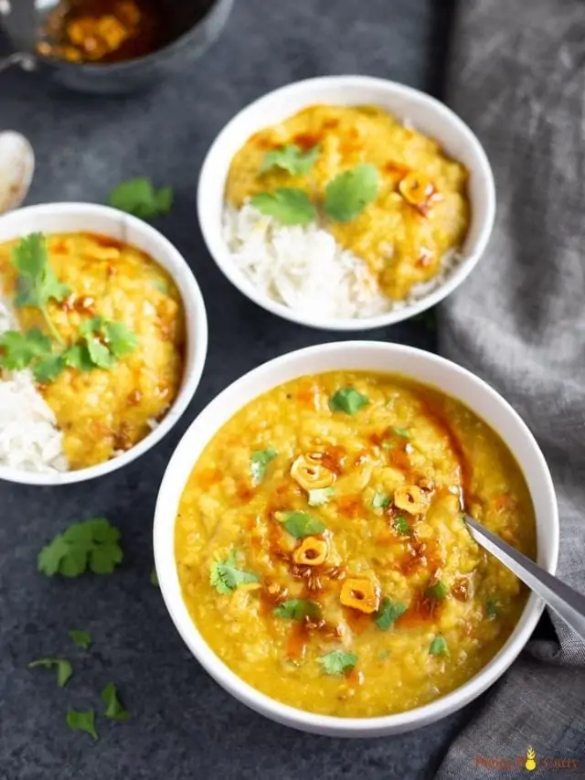 Red Lentils served in 3 bowls over rice and topped with cilantro
