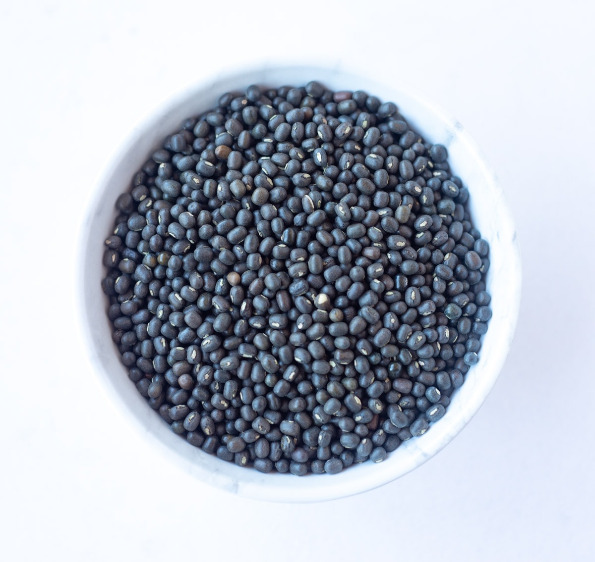 Black Matpe Beans (Sabut Urad) in a white bowl