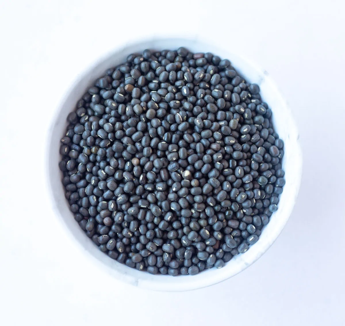 Black Matpe Beans (Sabut Urad) in a white bowl