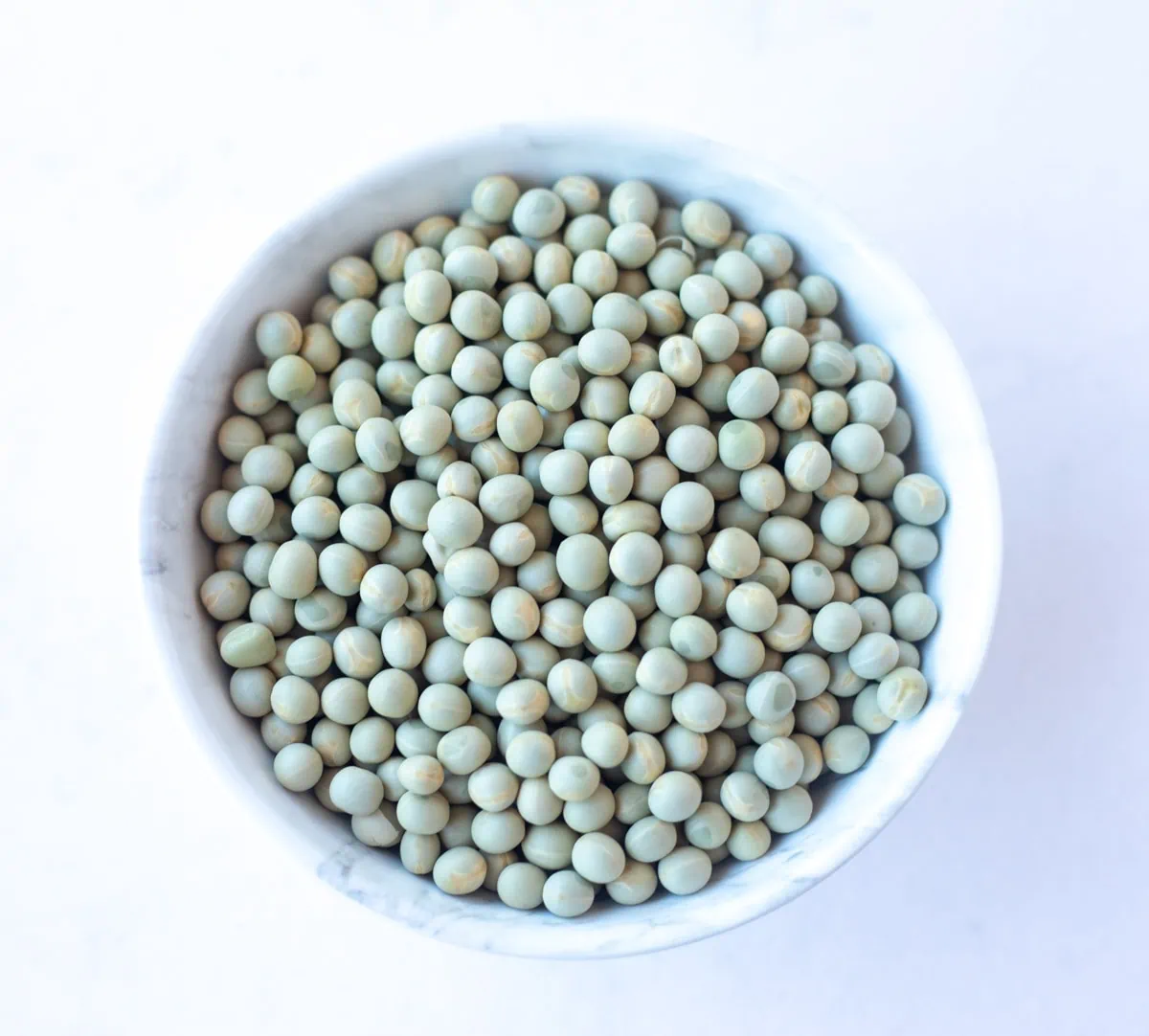 Dried Green Peas, also called Vatana in a white bowl 