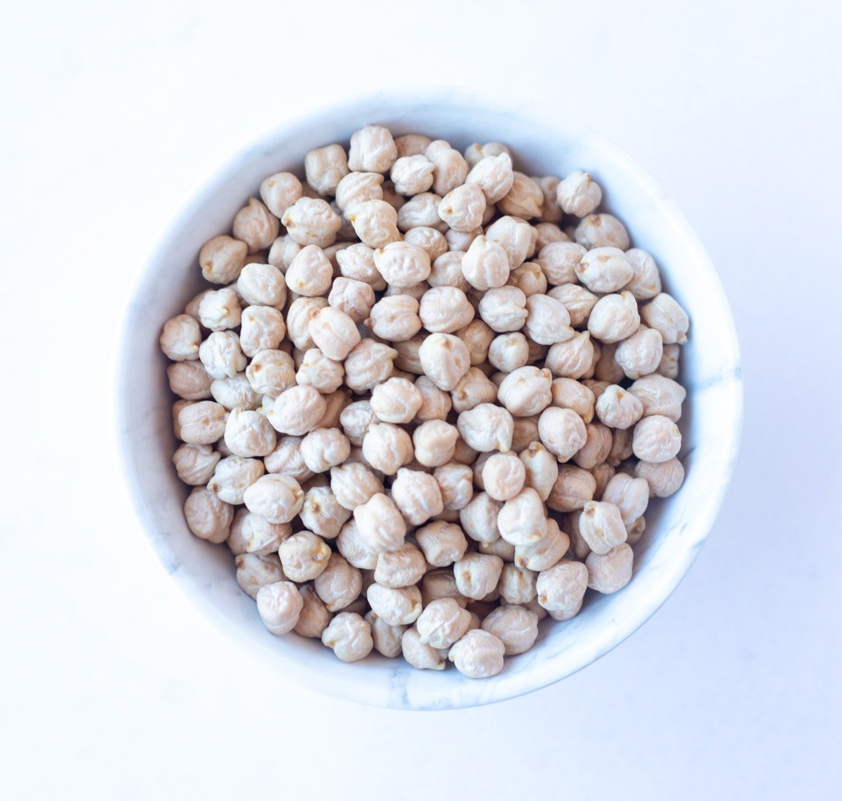 Garbanzo Beans, also called chickpeas or  Kabuli Chana or Chhole in a white bowl