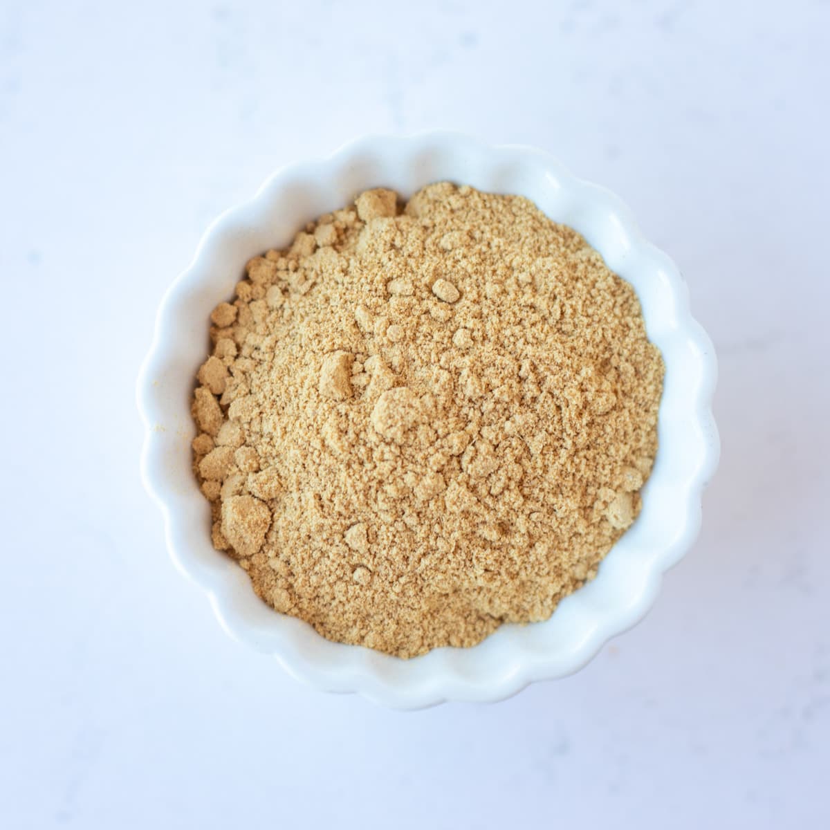 Ginger powder in a small white bowl.