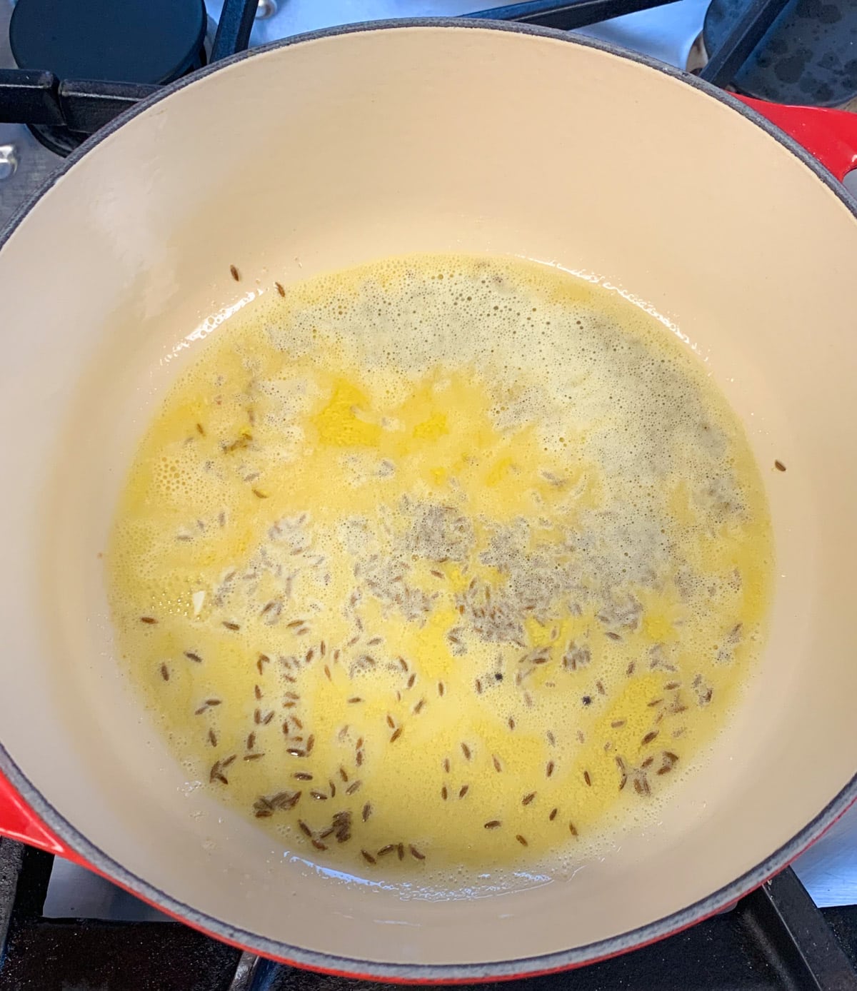 Heat ghee and add cumin seeds in a pan 