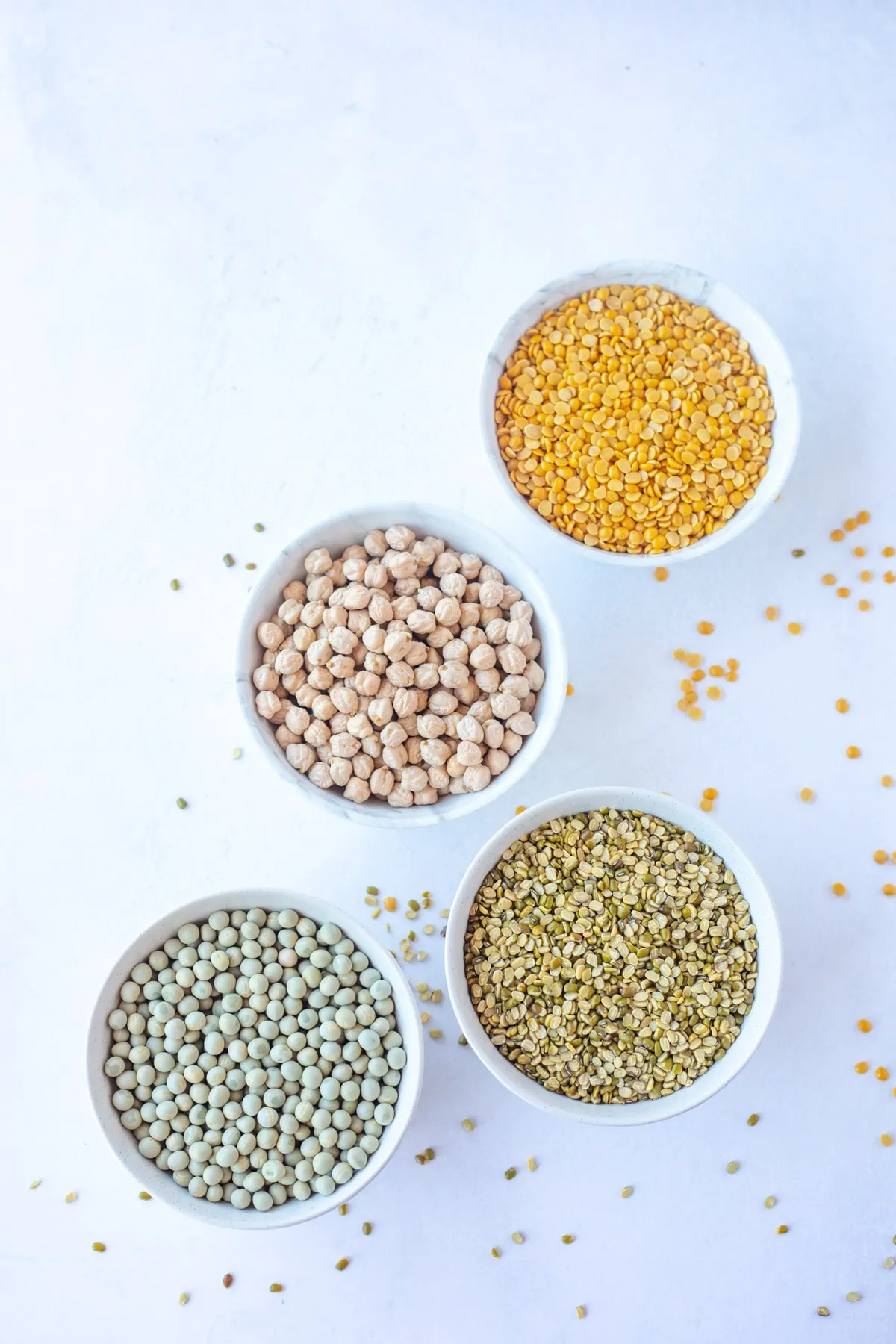 Indian pulses in white bowls 