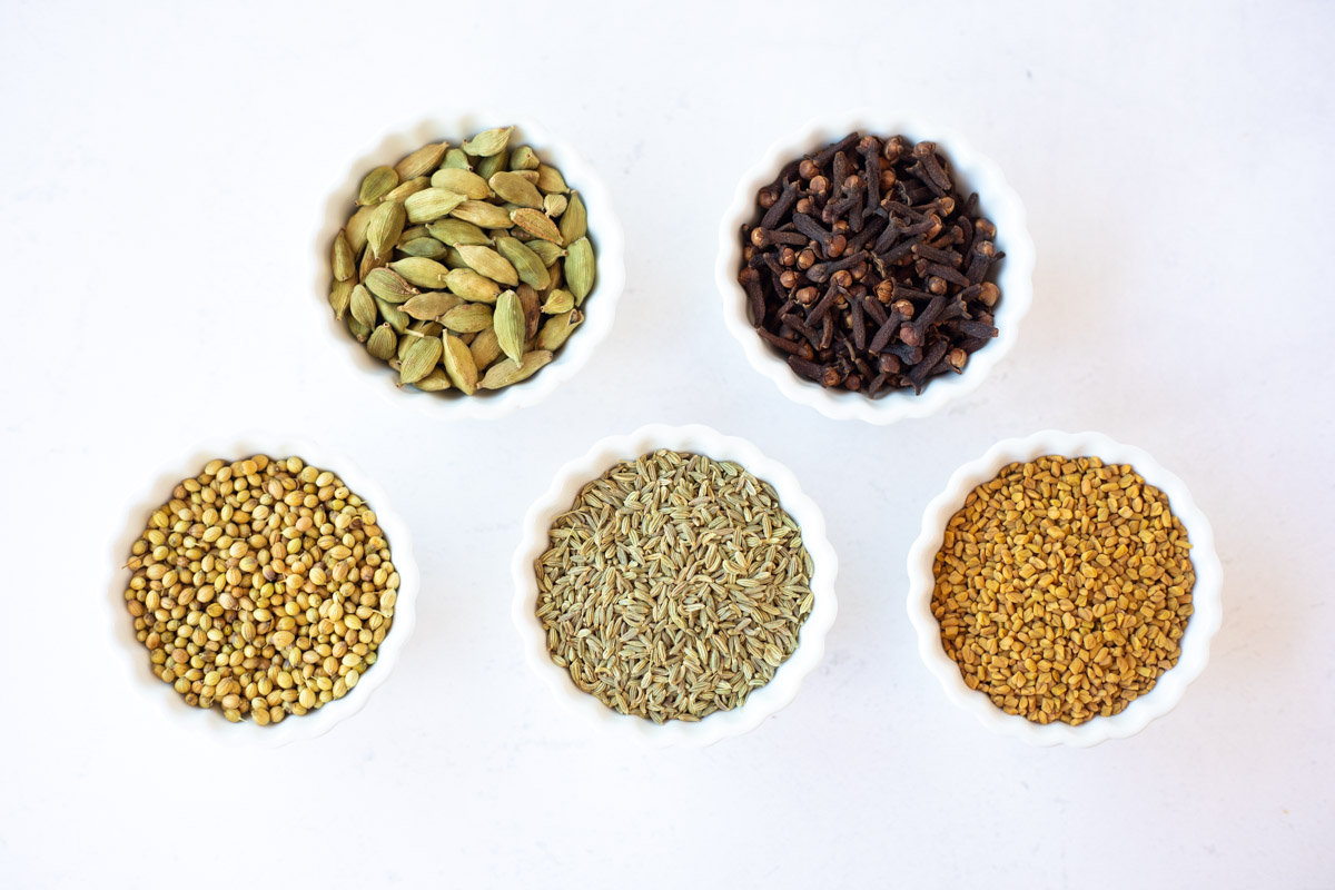 Indian spices in small white bowls