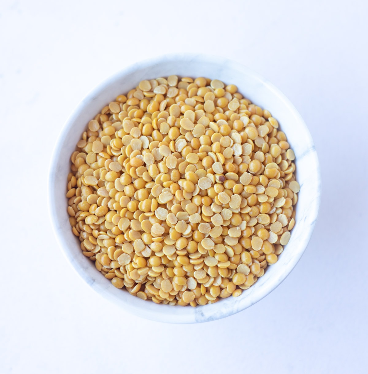 Pigeon Peas, also called Toor Dal or Arhar Dal in a white bowl 