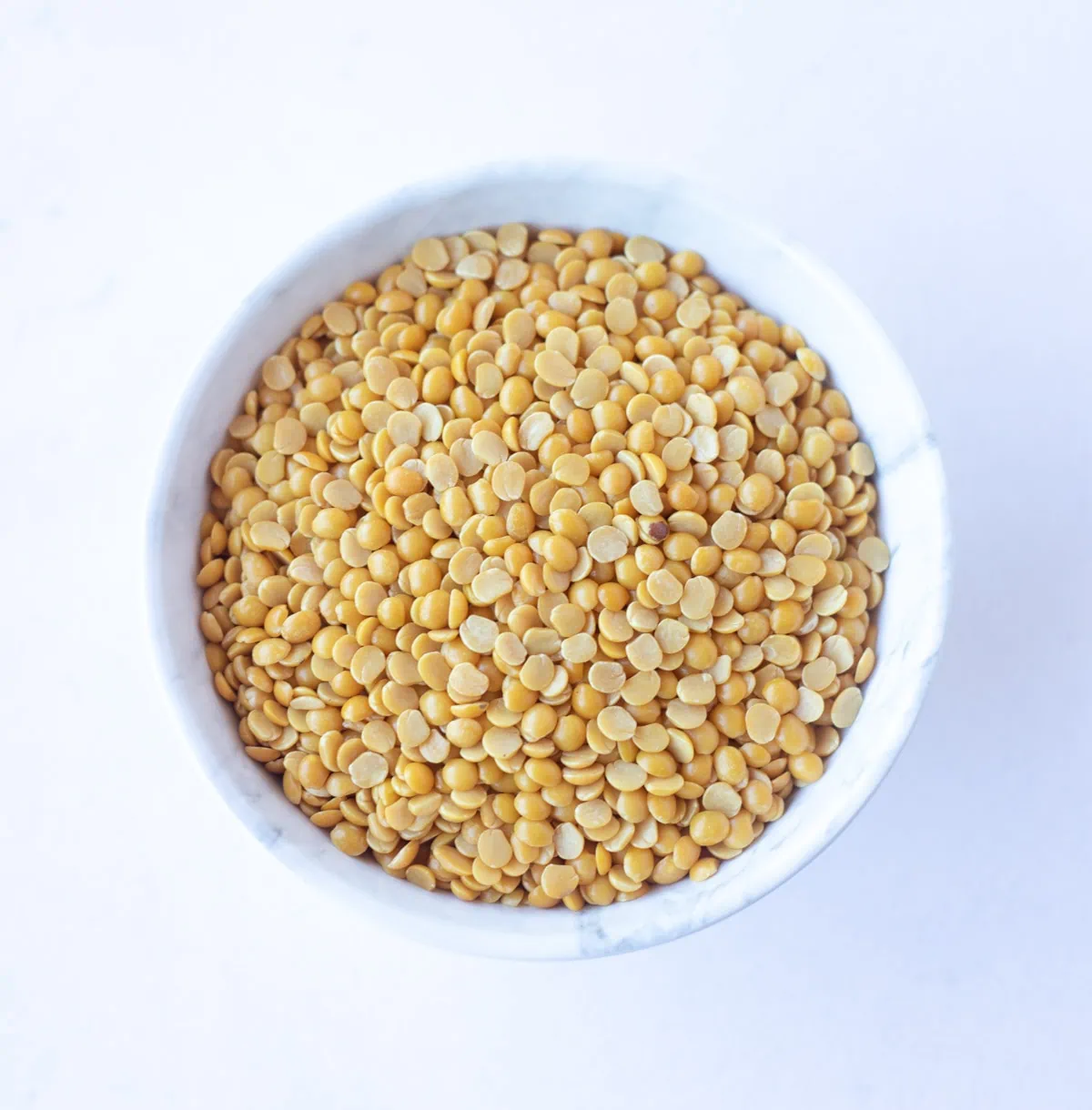 Pigeon Peas, also called Toor Dal or Arhar Dal in a white bowl 