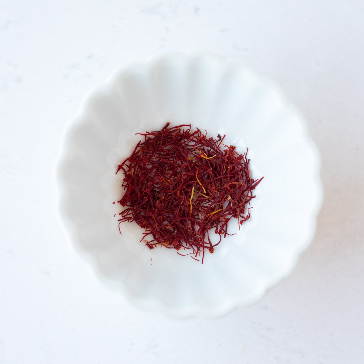 Saffron in a small white bowl.