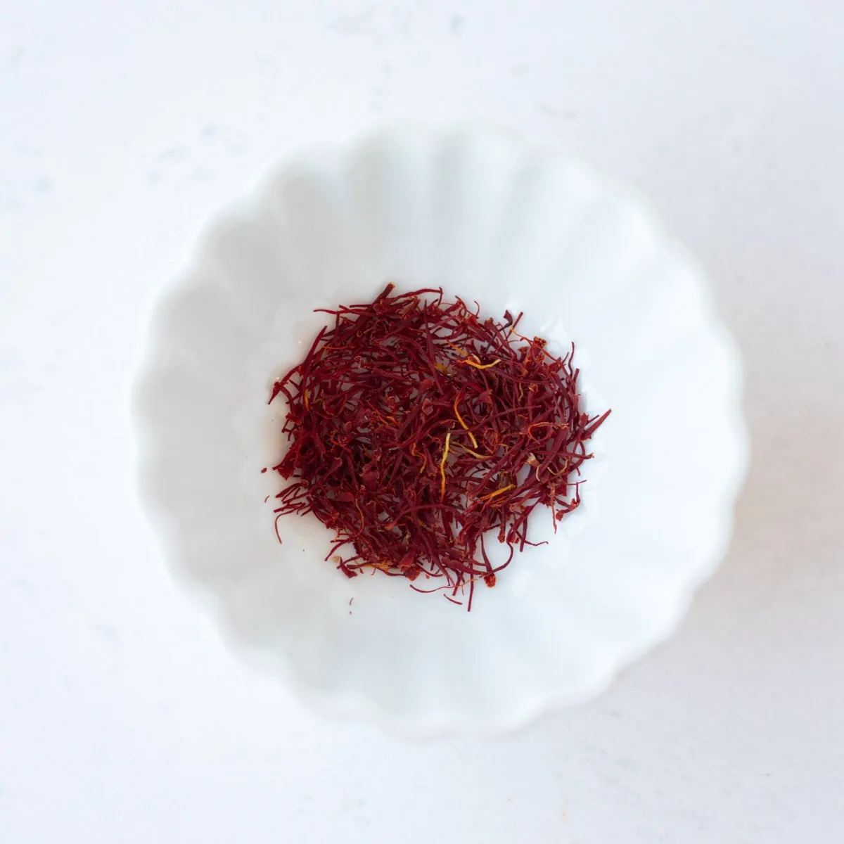 Saffron in a small white bowl.