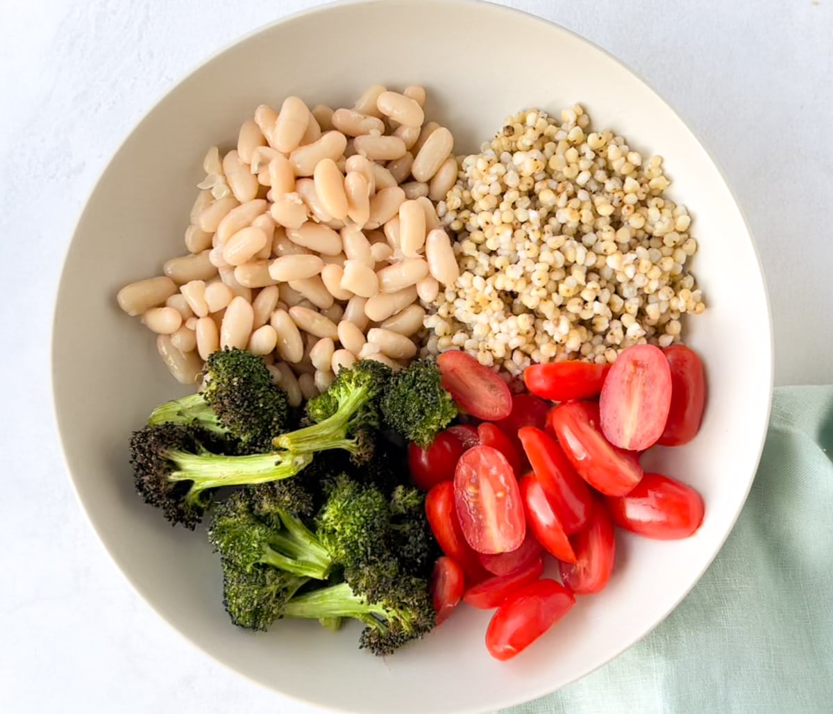 Sorghum (jowar), beans, broccoli and tomatoes in a bowl