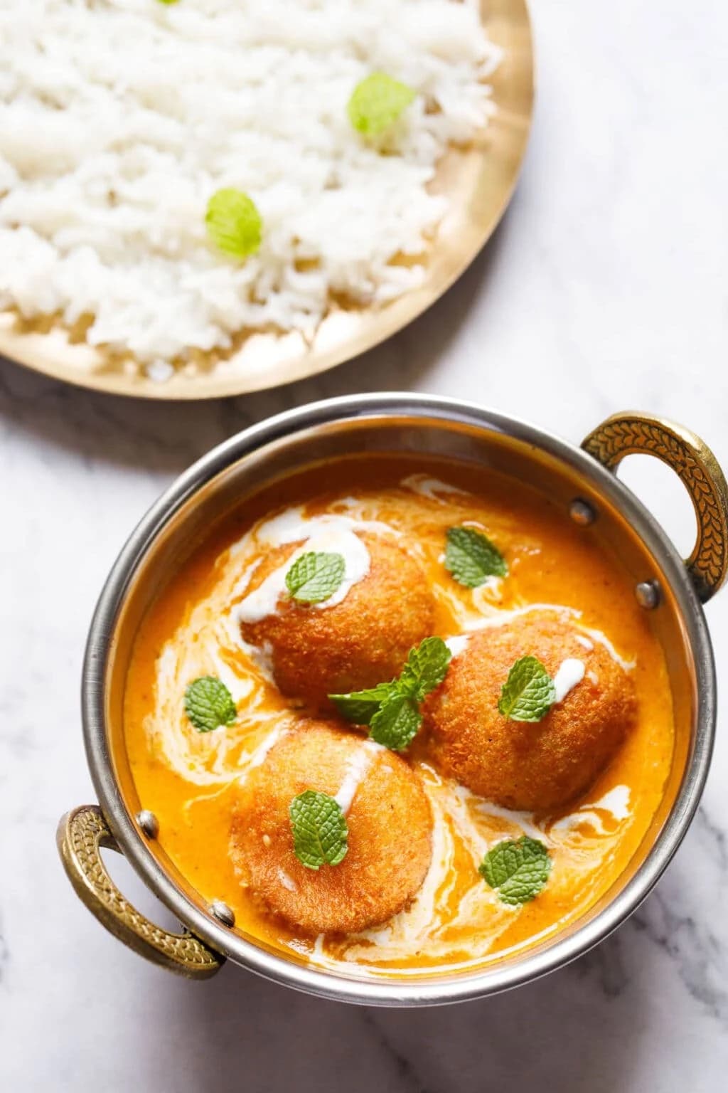 Malai kofta garnished with cilantro