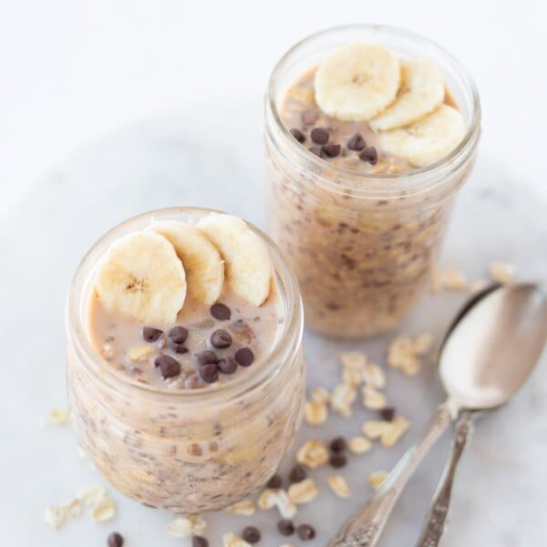 Overnight oats in a jar with spoons on the side