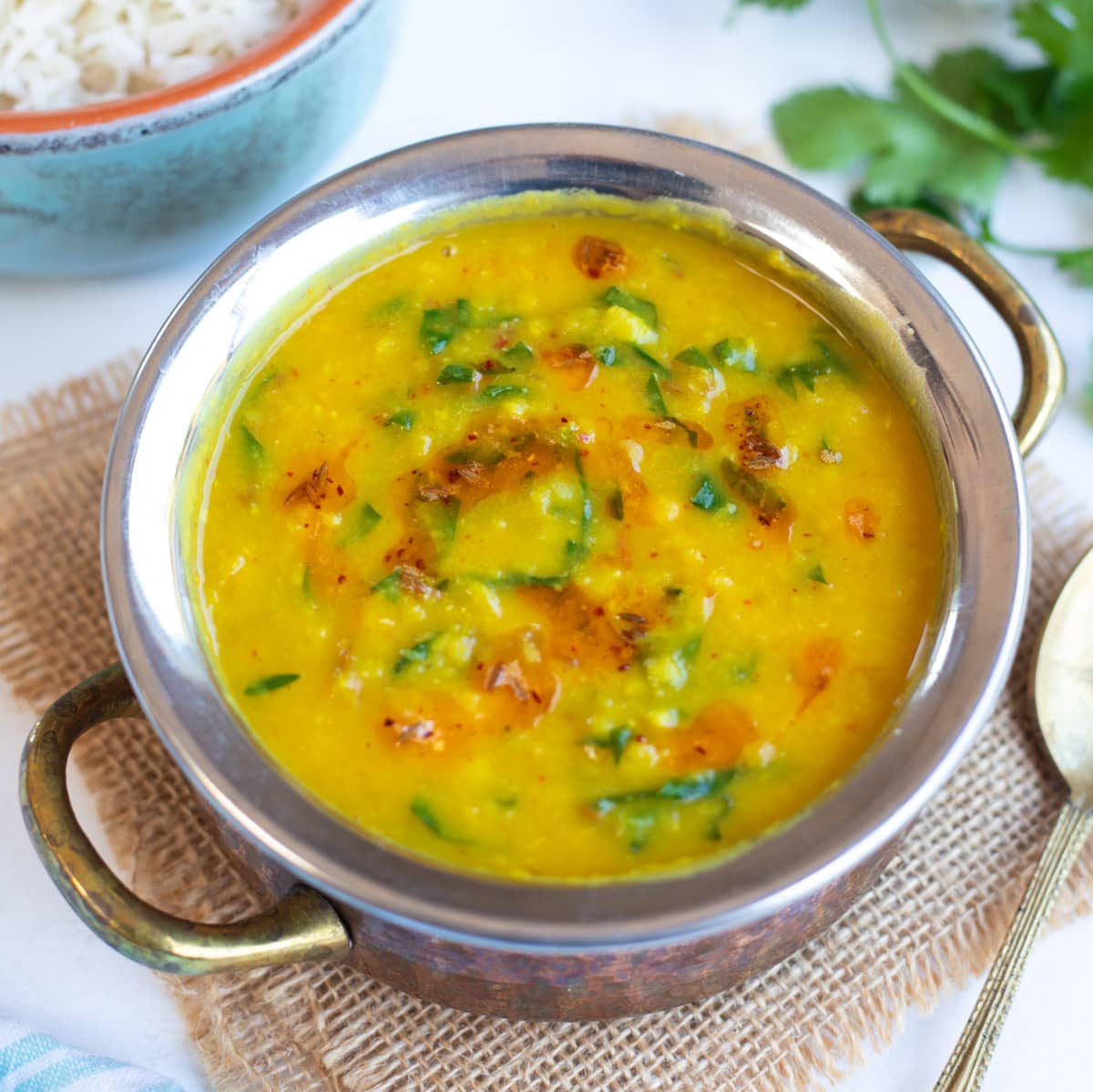 Dal Palak (Lentils with spinach) in a pretty bowl with rice on the side