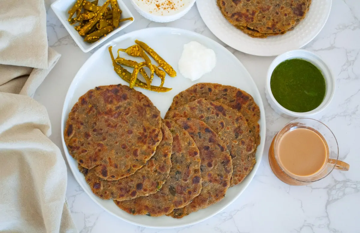 Methi na Dhebra recipe with tea, chutney and pickle on the side