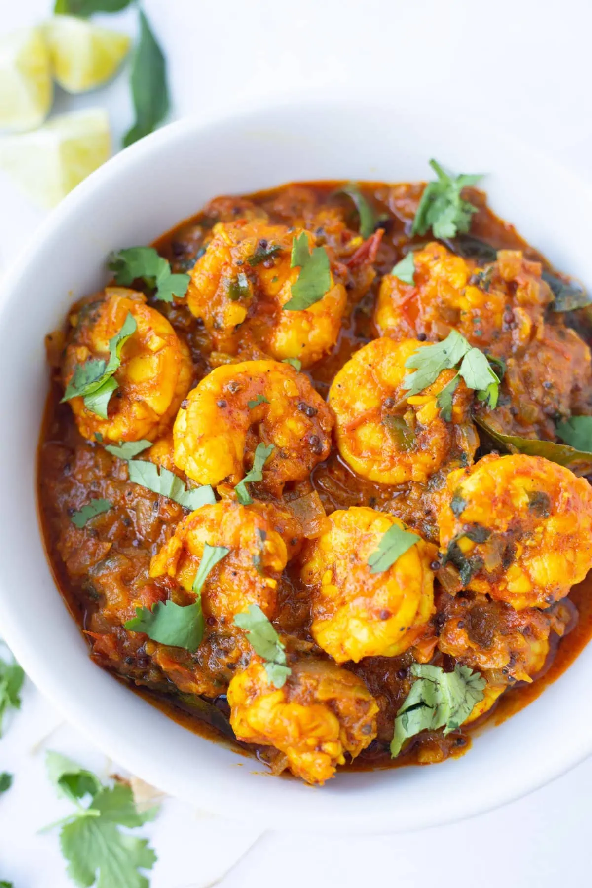 Shrimp Masala curry in a bowl garnished with cilantro leaves 