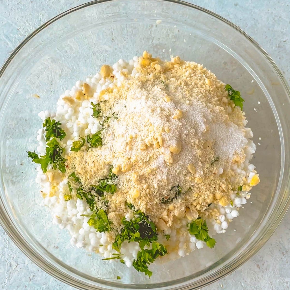 Crushed peanuts, cilantro, green chili, sabudana in a bowl