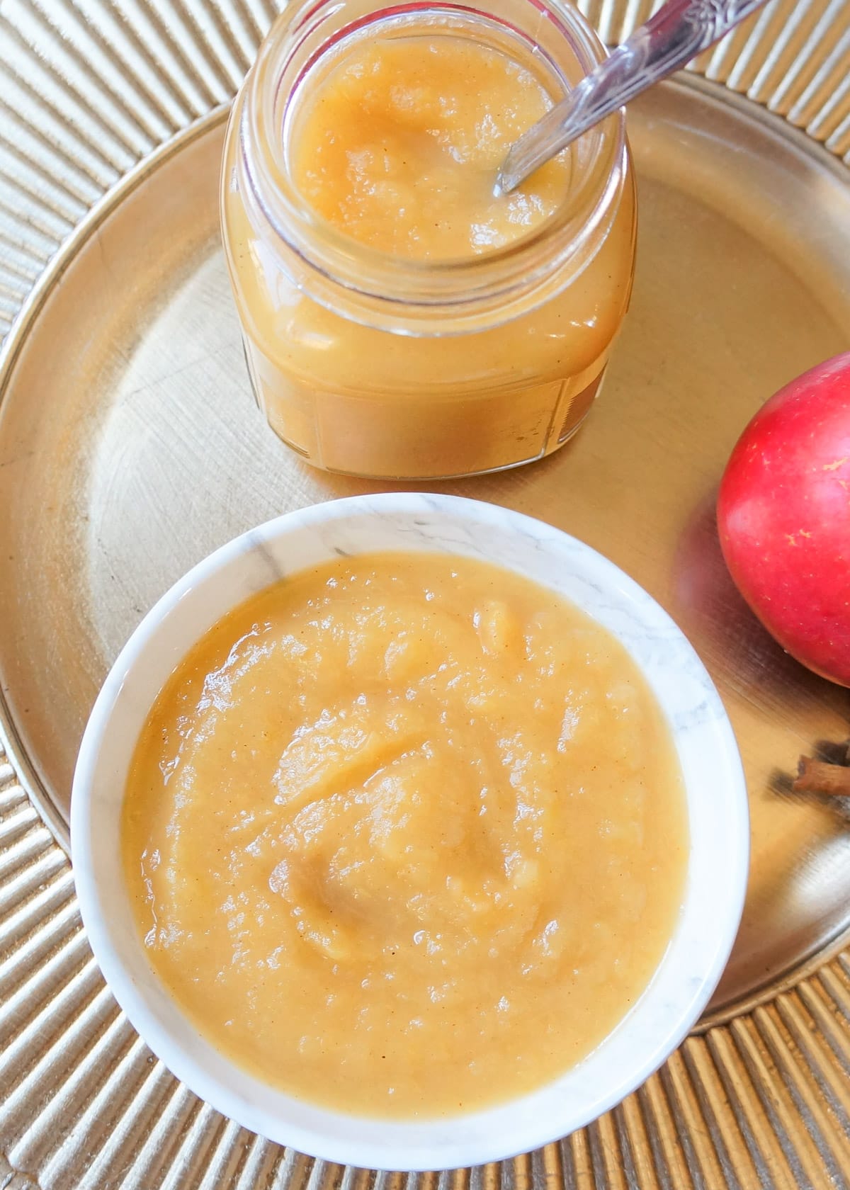 Applesauce in a white bowl and in a glass jar