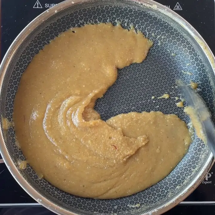 mixing badam halwa in a pan