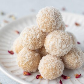 Almond ladoo with dessicaled coconut in a white plate
