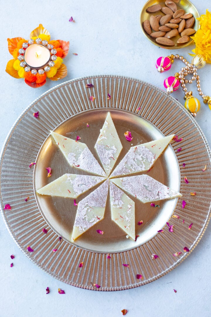 Badam burfi with almond flour with diva and almonds on the side