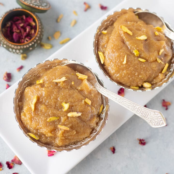 Badam halwa topped with pistachios in a bowl