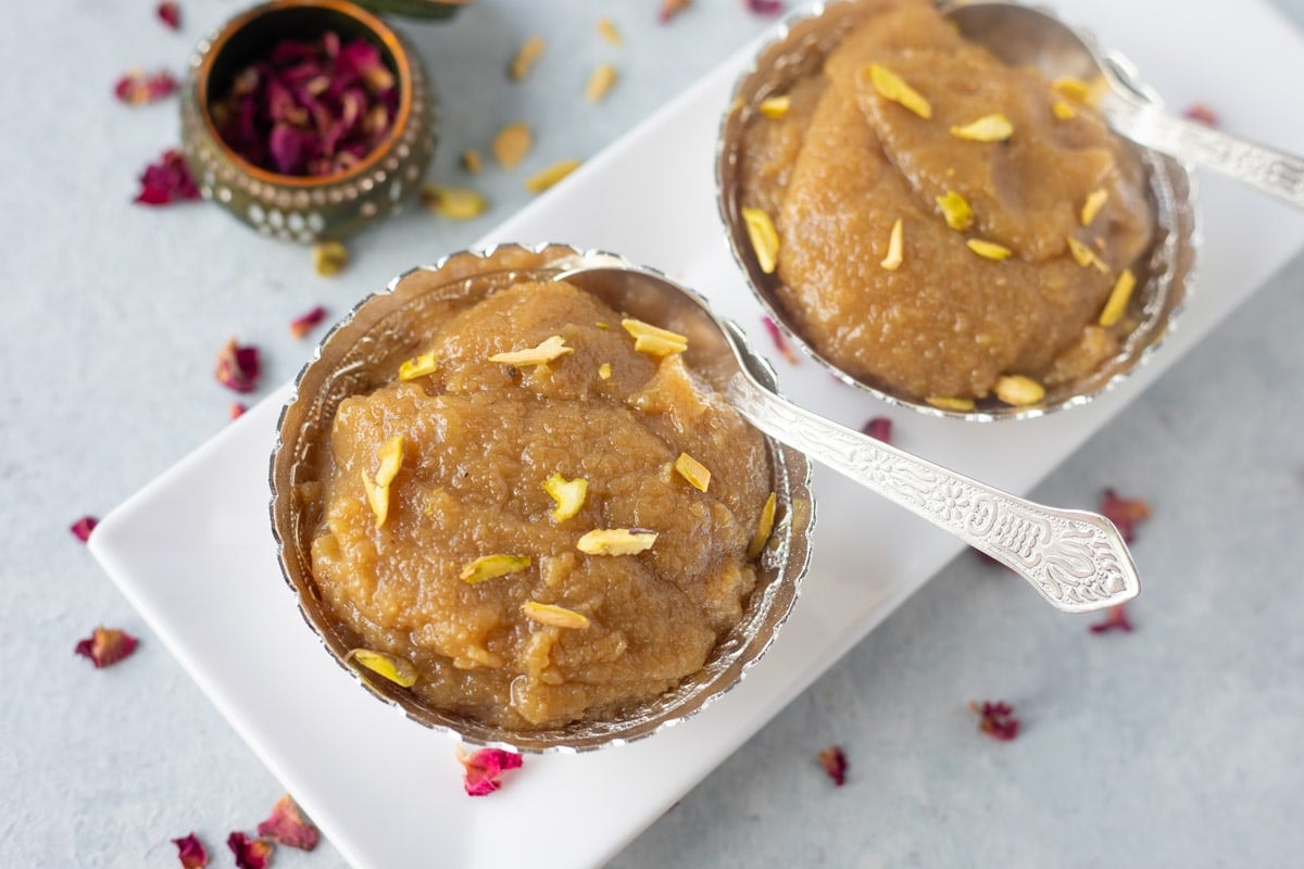 Two badam halwa in a small silver bowl