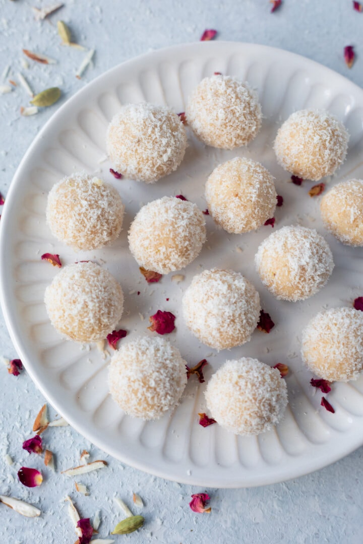 Coconut Almond Ladoo in a plate decorated with rose petals