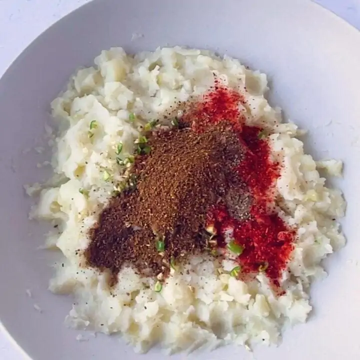 Add spices to the filling in a bowl