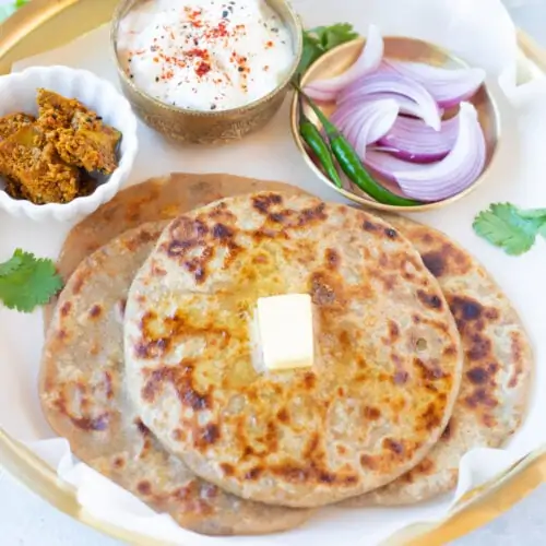 Spiced Indian Potato Paratha topped with butter