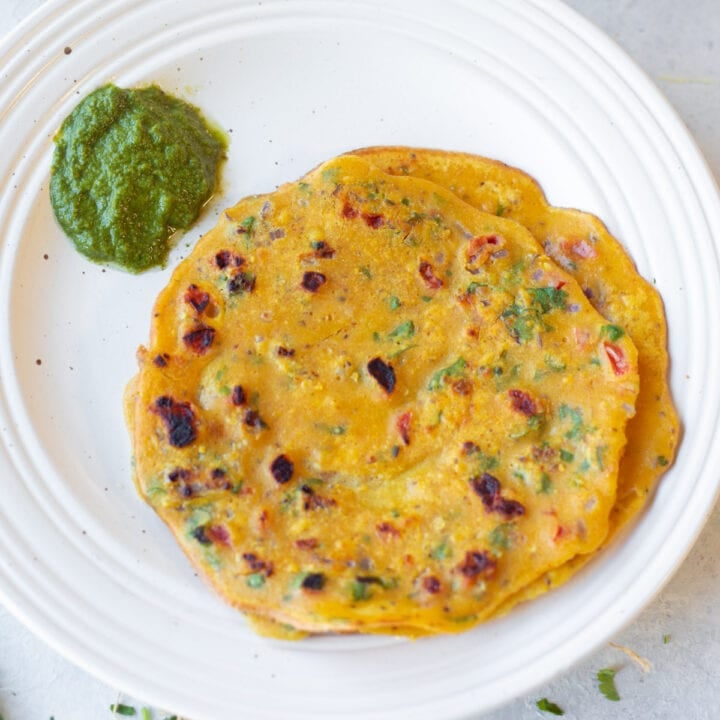 besan cheela (besan puda) in a white plate with chutney