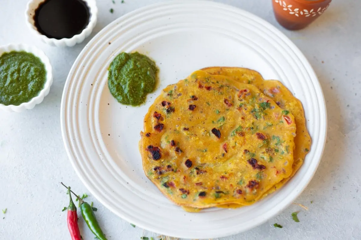 Besan ka Chilla (vegetarian omelette) served with green chutney in a plate