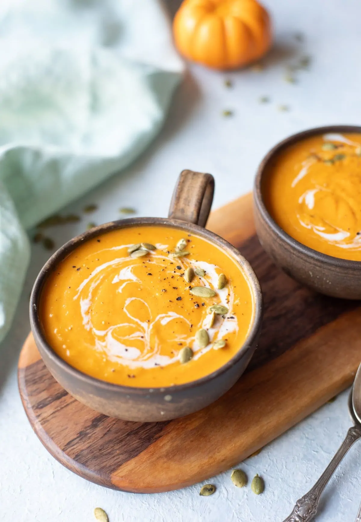 Creamy roasted pumpkin soup in a wooden bowl
