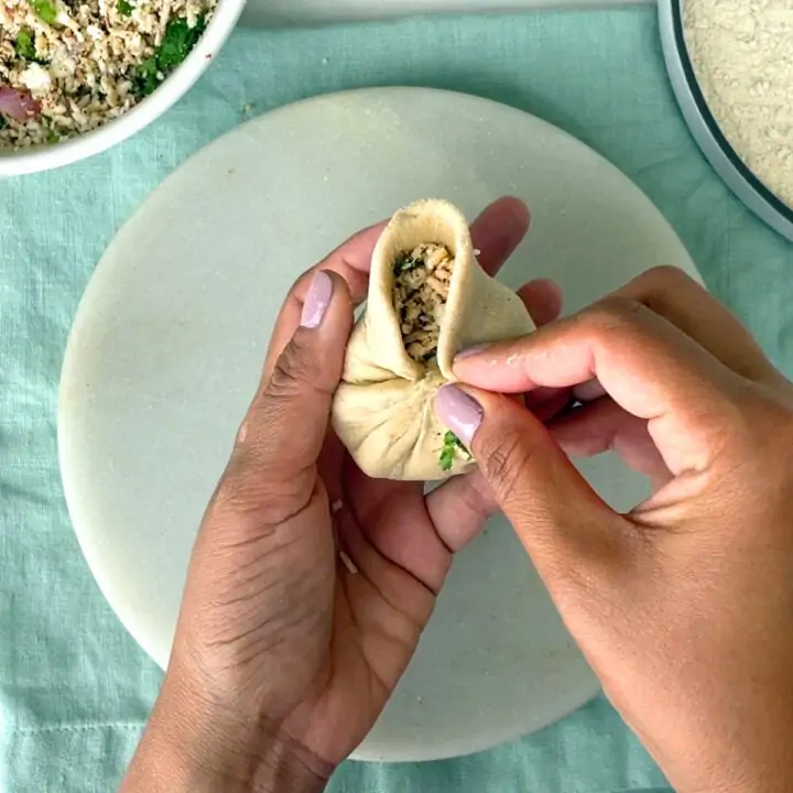 take pleats to seal the paneer ball
