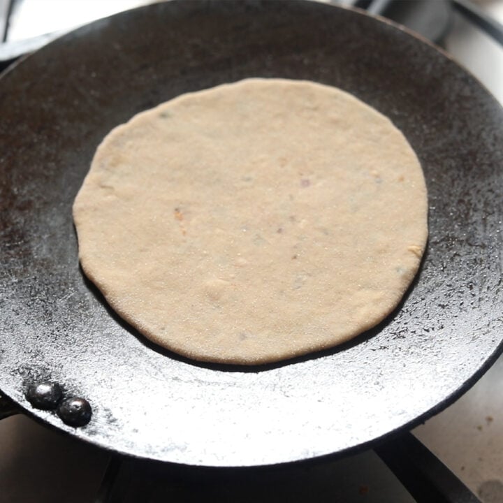 put rolled paratha on the tawa to cook
