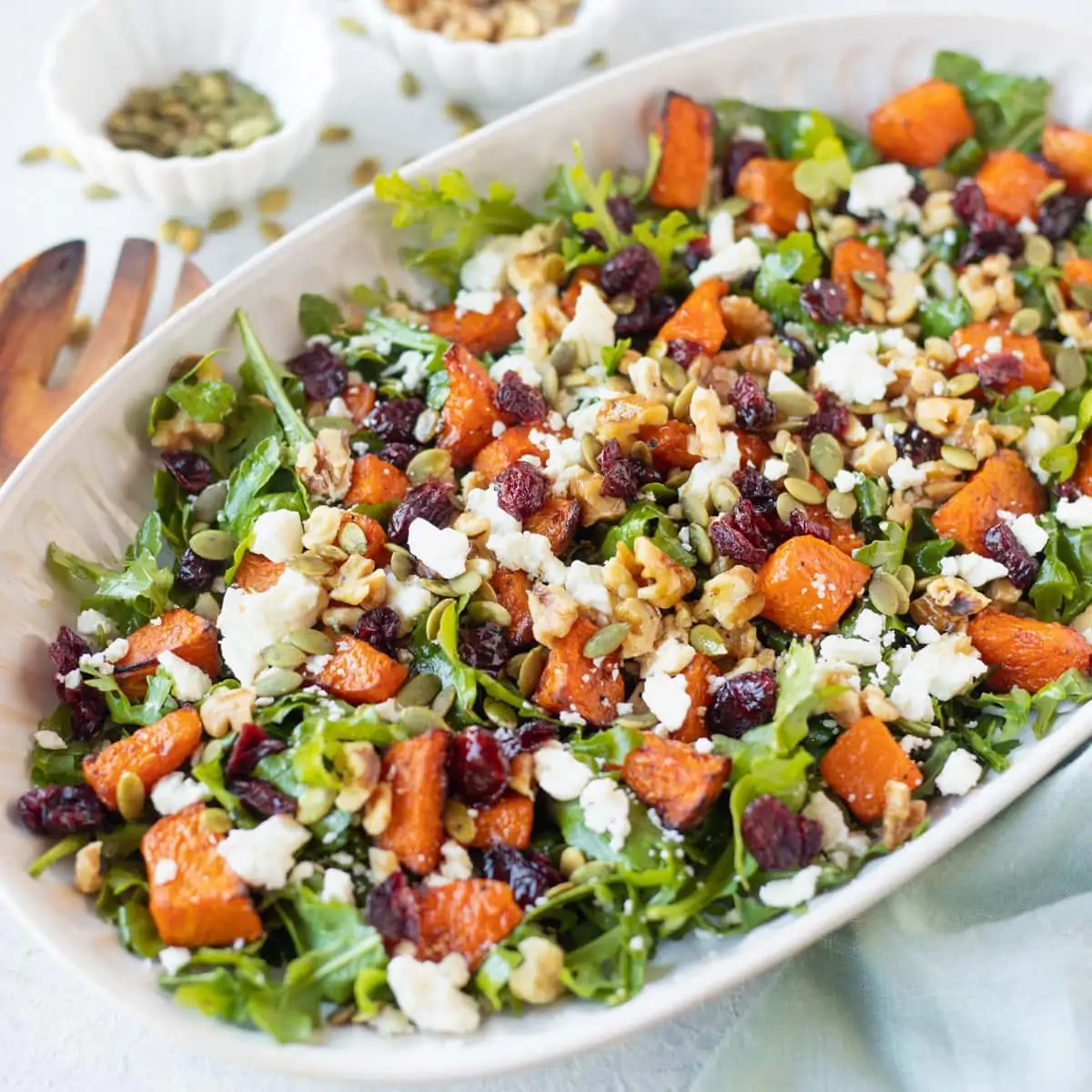 Pumpkin salad with feta and walnuts served in a platter
