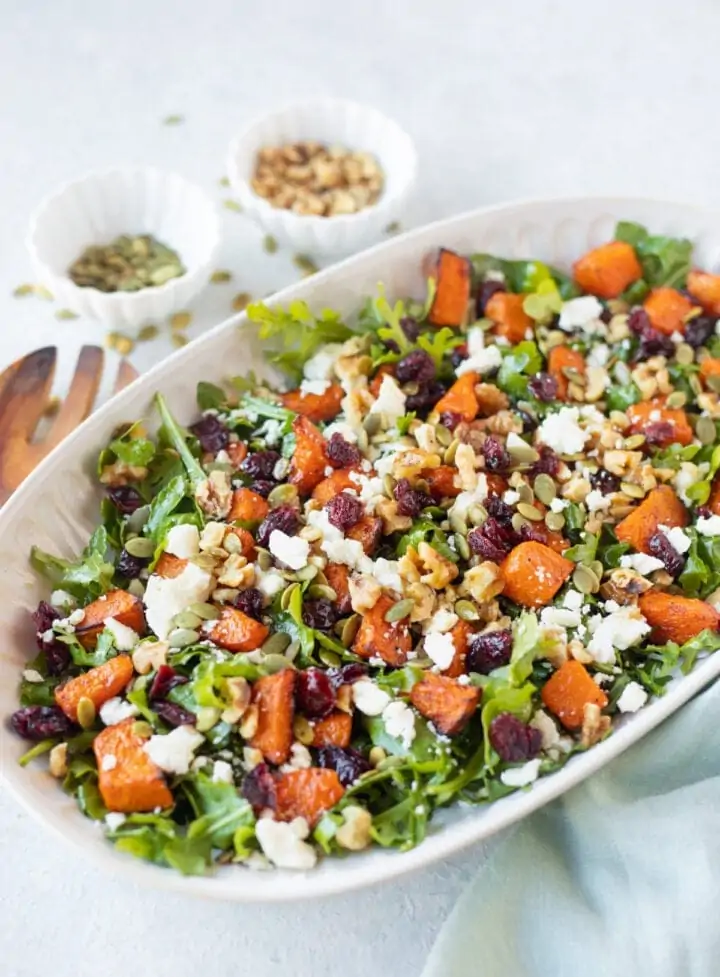 Roasted pumpkin salad with feta and walnuts served in a platter