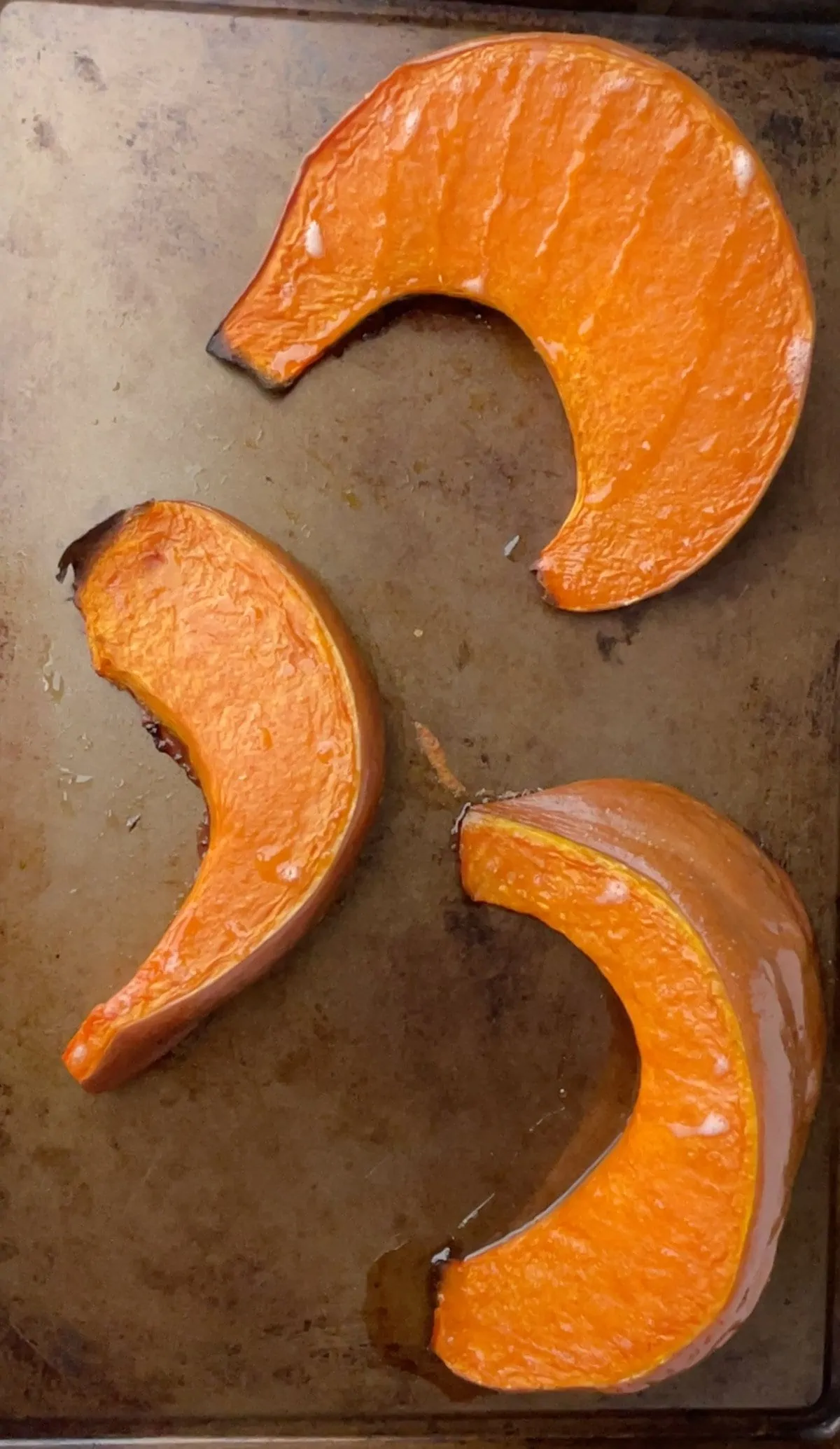 Roasted pumpkin slices on a baking sheet