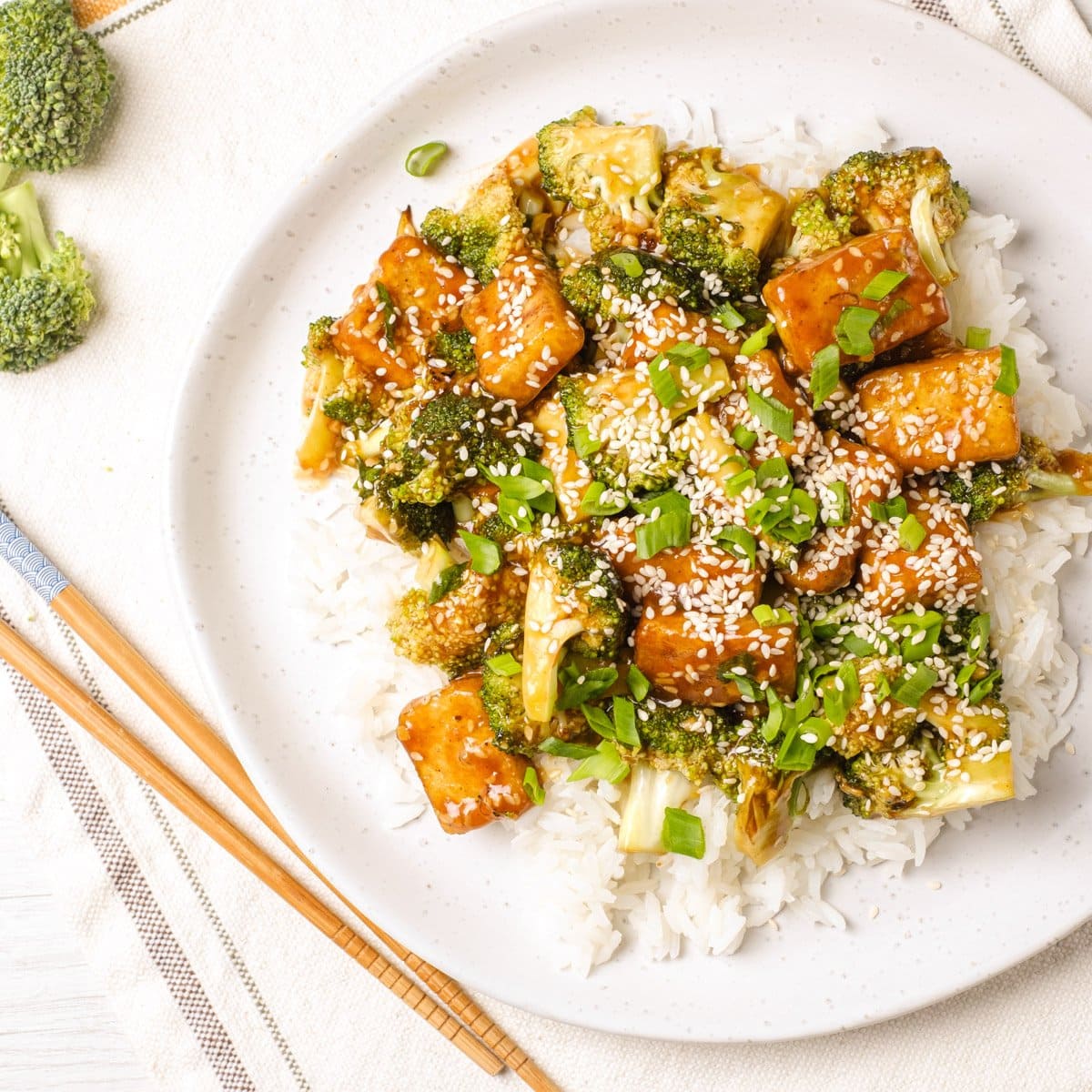 Tofu Broccoli Stir Fry in garlic sauce in a plate garnished with scallions