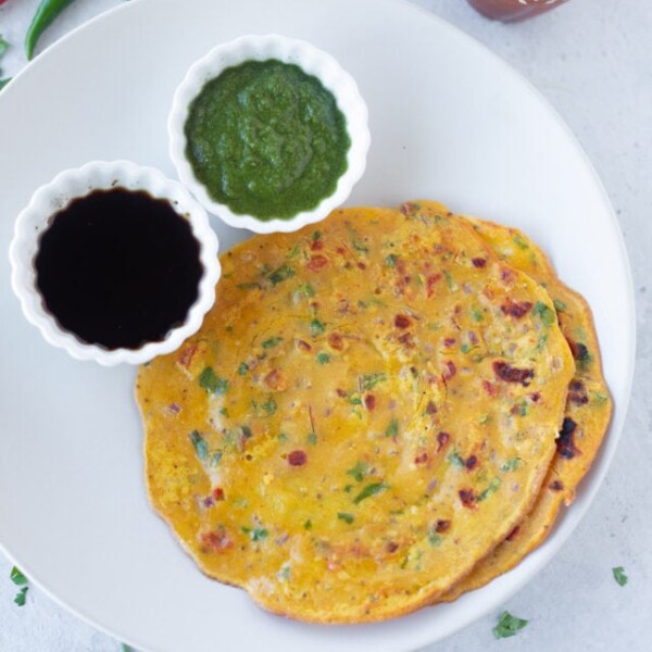 savory gram flour pancakes served in a plate