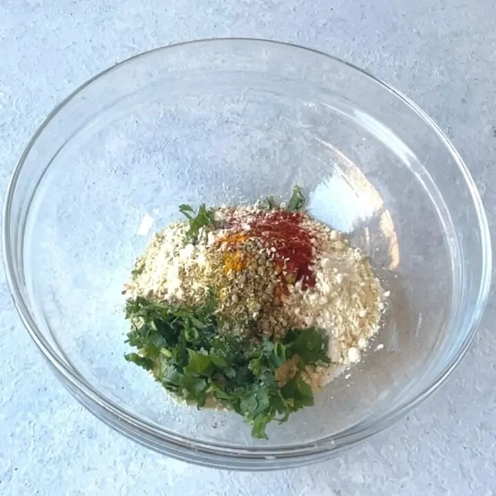 in a glass bowl add besan, spices and water