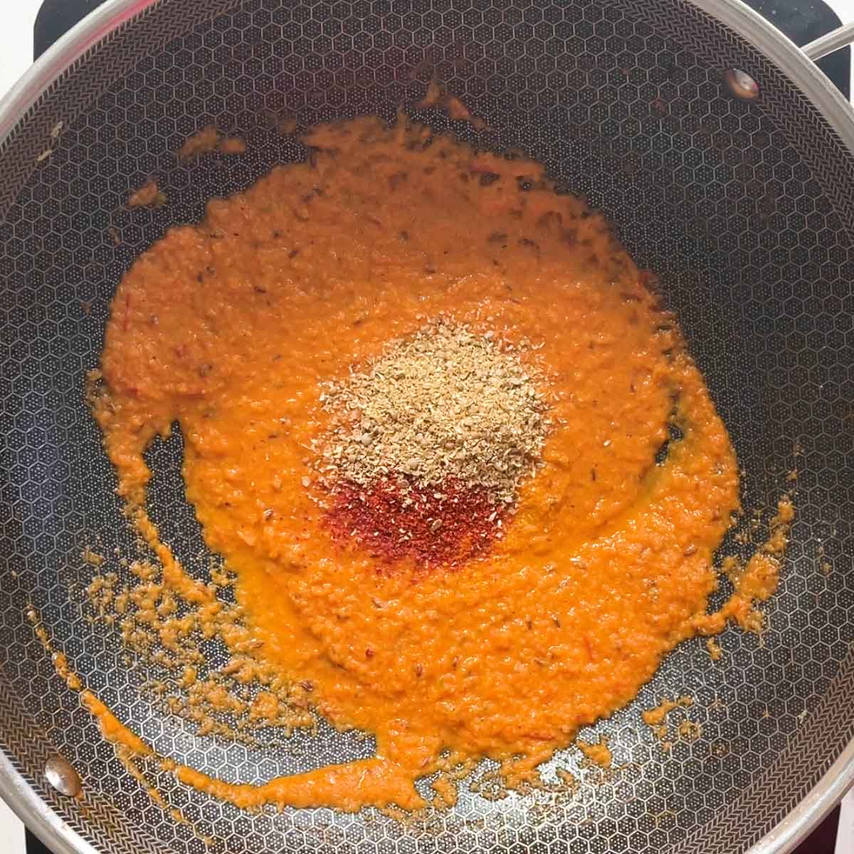Add spices to the onion tomato gravy