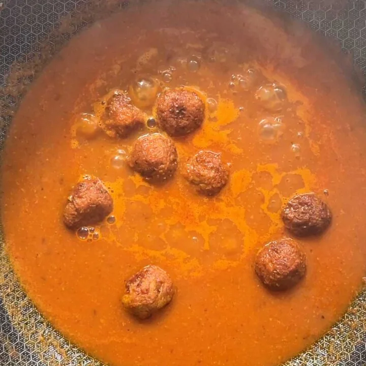 add fried kofta balls in the gravy and cook