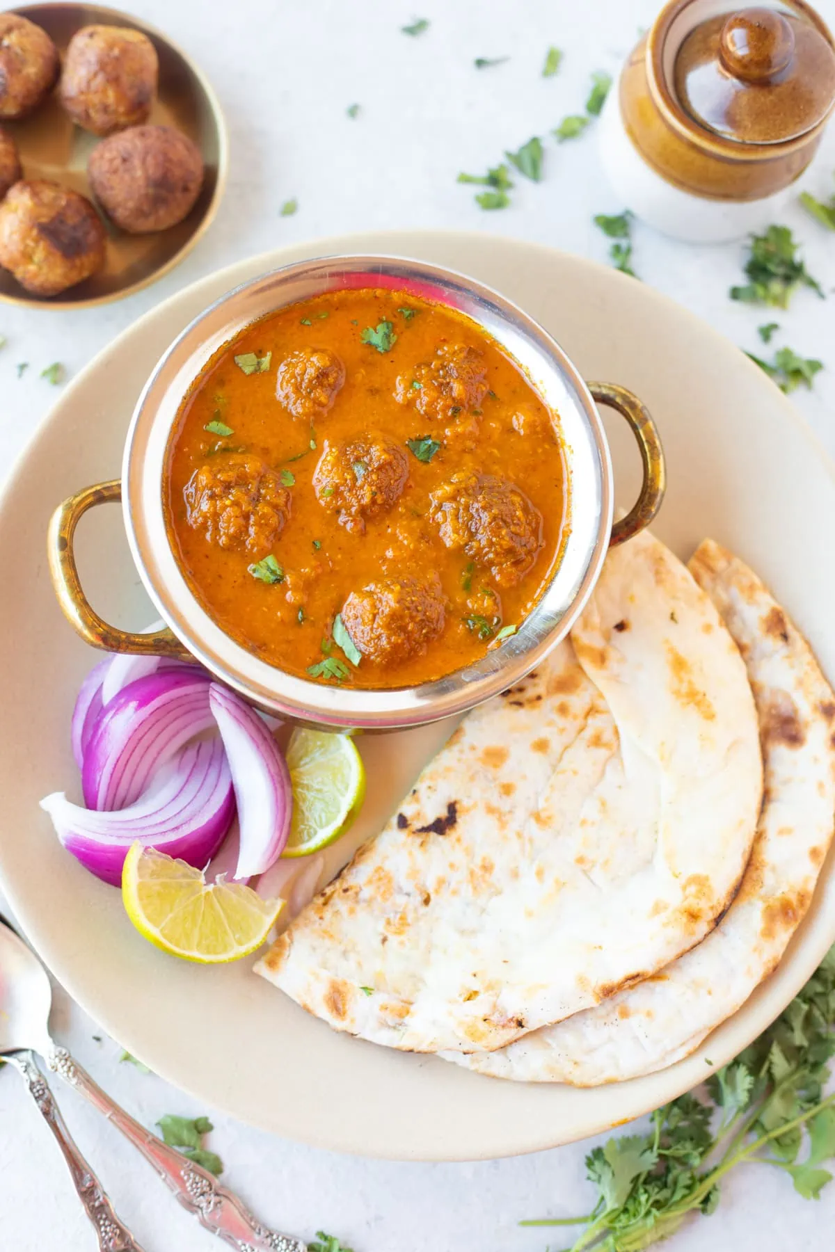 Lauki Kofta Curry with naan and onion in a plate