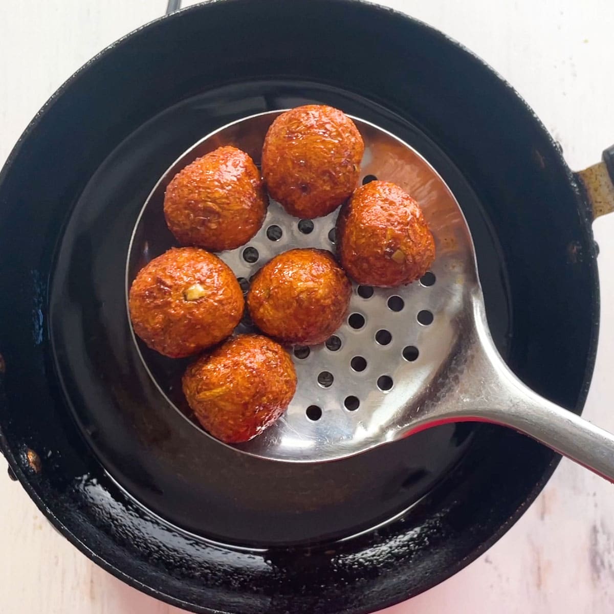 Fried Lauki balls in laddle