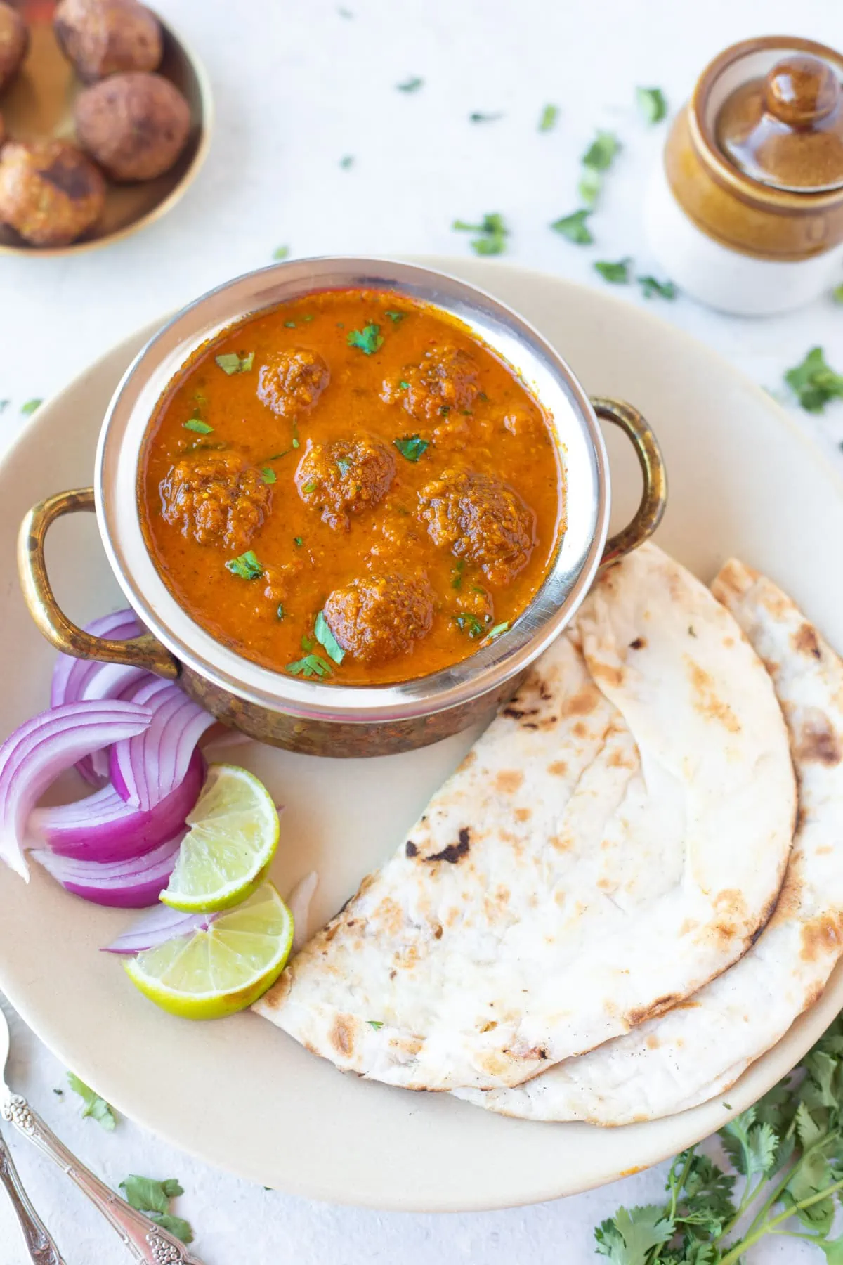 Lauki Kofta with onion and lemon on the side