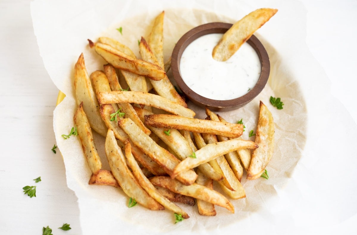 crispy homemade French fries made in the instant pot air fryer lid in a plate with dip