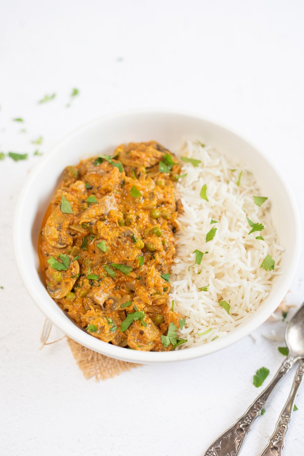 instant pot mushroom masala in a white bowl with rice