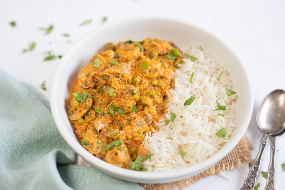 instant pot mushroom matar with rice and spoons on the side